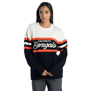 A woman modeling a Cincinnati Bengals crewneck sweater. The sweater features a cream upper chest and shoulders, black sleeves and lower body, and orange and white stripes across the chest and upper arms.